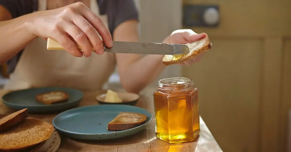 Pouring the final, pure honey into a jar.